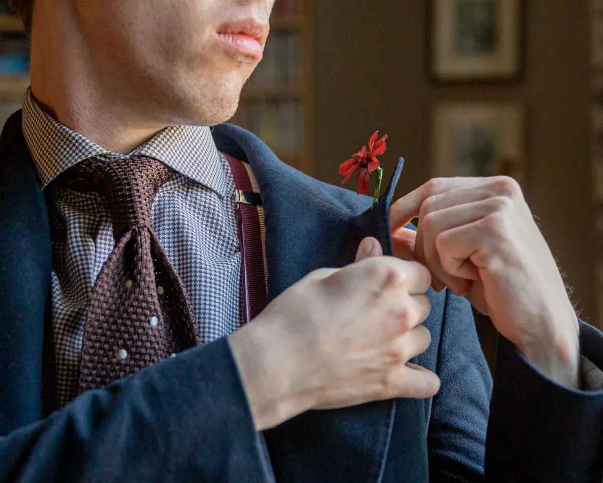 How is a boutonnière attached to the lapel?